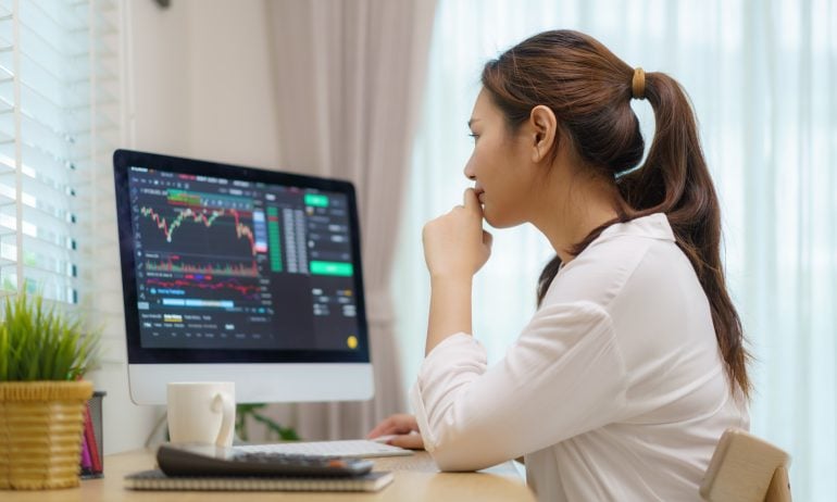 person seated at a home computer viewing stock screener/analysis of the magnificent seven stocks